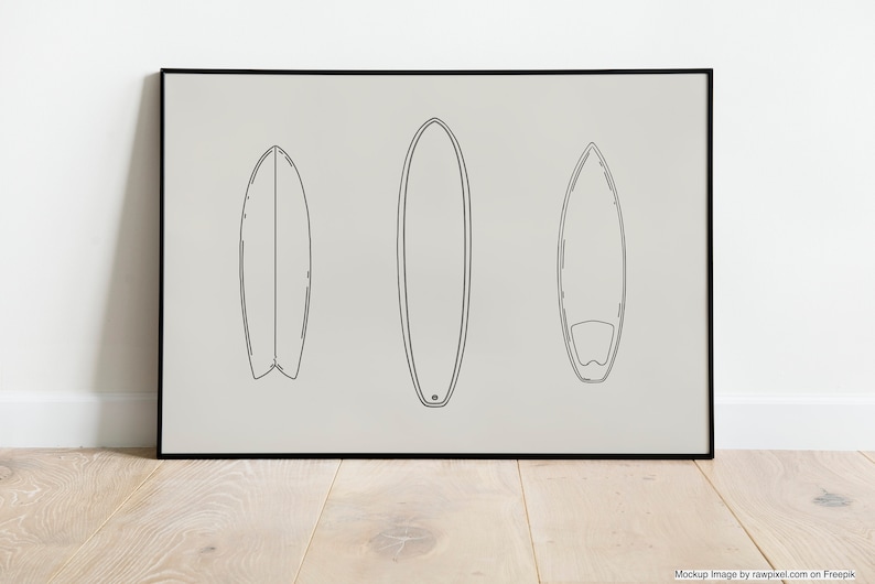 May include: A black framed print with a minimalist line drawing of three surfboards on a light gray background.