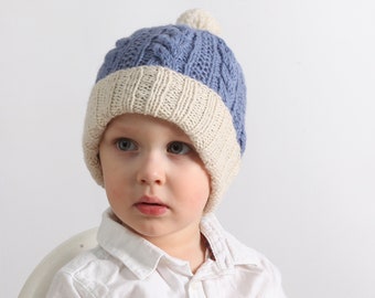 A classic, warm, soft children's cap with a pom-pom. Made from a blend of wool and alpaca. Blue, very warm, covers the ears.