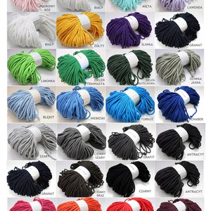 May include: A collection of 25 spools of cotton cord in various colors, including white, beige, green, blue, gray, black, red, orange, yellow, and pink. Each spool is labeled with the color name in Polish.