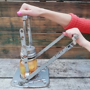 Antique way closure of jars and glass bottles, Primitive way of preserving, Metal kitchen utensil, Primitive way of closing jars and bottles