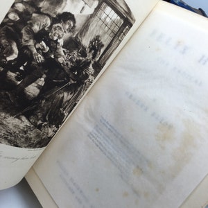 May include: A black and white illustration of a group of people gathered around a table in a dimly lit room. The illustration is from a vintage book.