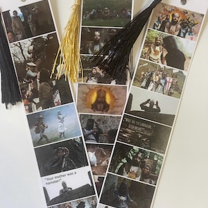 May include: Set of three bookmarks featuring scenes from the movie Monty Python and the Holy Grail. The bookmarks are printed on white cardstock and have black tassel accents. The scenes include a knight in armor, a group of knights, and a scene with the text "What all you gonna do, bleed on me?"