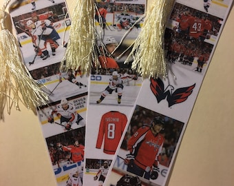 May include: Set of six bookmarks featuring images of hockey players wearing red and white jerseys. The bookmarks have tassels and feature the Washington Capitals logo. The text "DEVILS CHECK HERE" and "OVECHKIN 8" are visible on the bookmarks.