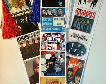 May include: A bookmark featuring album covers from popular 1960s British rock bands, including The Beatles, The Rolling Stones, The Animals, The Kinks, Gerry and the Pacemakers, The Who, and Herman's Hermits.