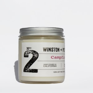 May include: A white candle jar with a silver lid. The label reads "No: 2 Winston + Pet Campfire" and "Hand Poured in California 100% Soy Wax Candle".