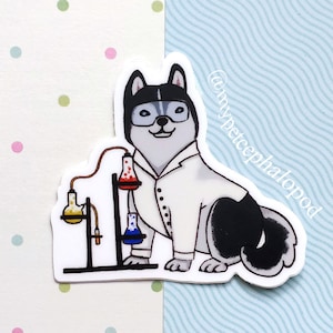 May include: A sticker featuring a cartoon husky wearing a white lab coat and holding a beaker. The husky is standing next to a chemistry set with beakers and a flask. The sticker has the text "@mycephalopad" on the right side.