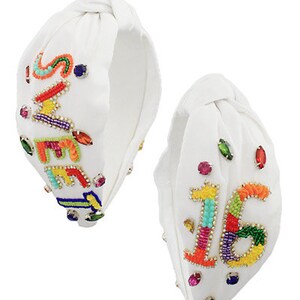 May include: Two white fabric headbands with colourful beaded embellishments. One headband features the word "Sweet 16" and the other features the word "Sweet Sixteen".