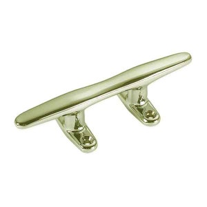 May include: A polished, gold-toned boat cleat. This marine hardware features a curved top and two mounting bases with pre-drilled holes. The cleat is designed for securing ropes and lines on boats and docks.