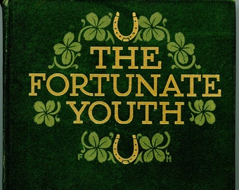 May include: A green book cover with gold lettering that reads "The Fortunate Youth" and "William J. Locke". The cover is decorated with shamrocks and horseshoes.
