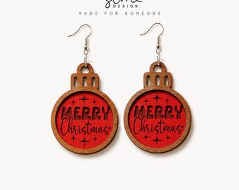 May include: A pair of wooden Christmas ornament earrings with silver-toned hooks. Each earring features a circular brown wood frame surrounding a bright red center with the text Merry Christmas and star accents engraved in black.