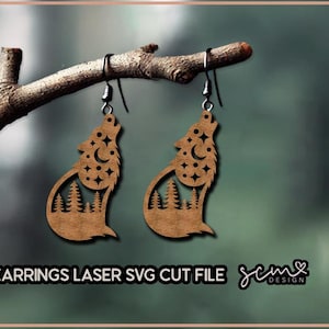 May include: A pair of laser cut wooden earrings featuring a howling wolf silhouette with a crescent moon and stars inside. The earrings are hanging from a branch.