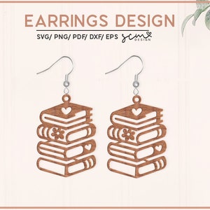 May include: A pair of wooden earrings shaped like a stack of books. Each book has a small heart or flower design on the front. The earrings are brown and have silver hooks.