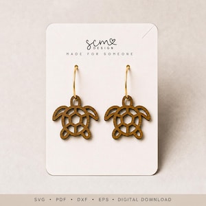 May include: A pair of brown wooden turtle-shaped earrings with gold-toned metal hoops attached to a white display card featuring the text scm DESIGN MADE FOR SOMEONE. The bottom of the card displays the text SVG PDF DXF EPS DIGITAL DOWNLOAD.