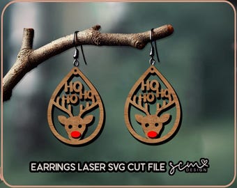 May include: A pair of laser cut wooden earrings shaped like a teardrop with a reindeer and the words "Ho Ho Ho" inside. The earrings are brown with a red nose on the reindeer.