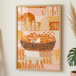 May include: A framed art print featuring a sleeping corgi in a woven basket filled with croissants. The background has a patchwork design with wheat and circular shapes in shades of orange, peach, and cream. The artwork is in a wooden frame.