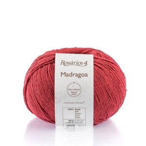 May include: A ball of red 100% silk yarn called "Madragoa" from the "Ros&aacute;rios 4" collection. The label says "Fibras Naturais Natural Fibers" and "Ecofriendly Collection".