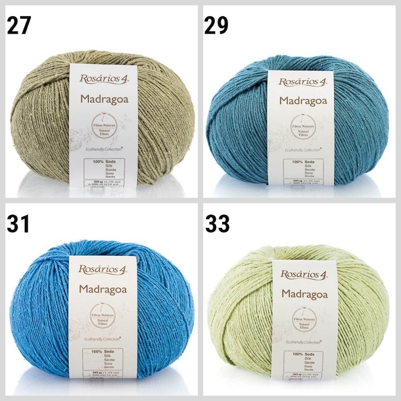 May include: Four skeins of yarn in different colors: green, blue, light blue, and light green. Each skein has a label that reads "Ros&aacute;rios 4. Madragoa" and includes information about the yarn, such as "Fibras Naturais Natural Fibers" and "Ecofriendly Collection".