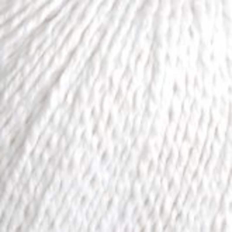 May include: Ball of white yarn, with a soft and fluffy texture.