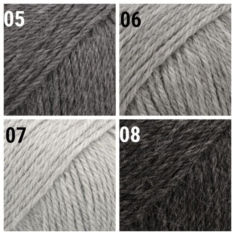 May include: Four skeins of yarn in different shades of gray. The skeins are labeled 05, 06, 07, and 08.