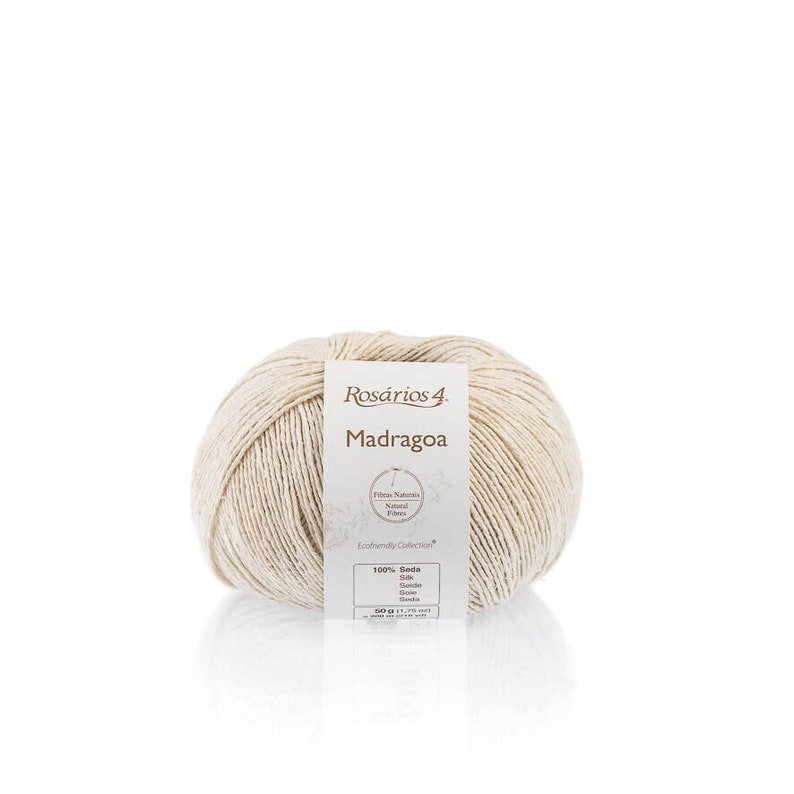 May include: A ball of beige yarn labeled "Rosarios 4 Madragoa" with a tag that reads "Fibras Naturales Natural Fibres Exclusively Collection 100% Seda Silk Seta Seide Soie Seide Seda"