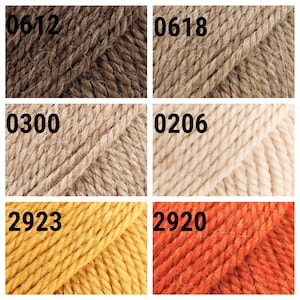 May include: Six skeins of yarn in different colors: brown, beige, light beige, yellow, and orange. The yarn skeins are labeled with numbers: 0612, 0618, 0300, 0206, 2923, and 2920.