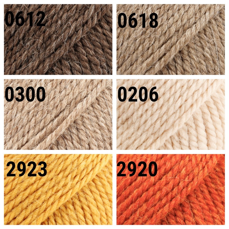 May include: Six skeins of yarn in different colors: brown, beige, light beige, yellow, and orange. The yarn skeins are labeled with numbers: 0612, 0618, 0300, 0206, 2923, and 2920.