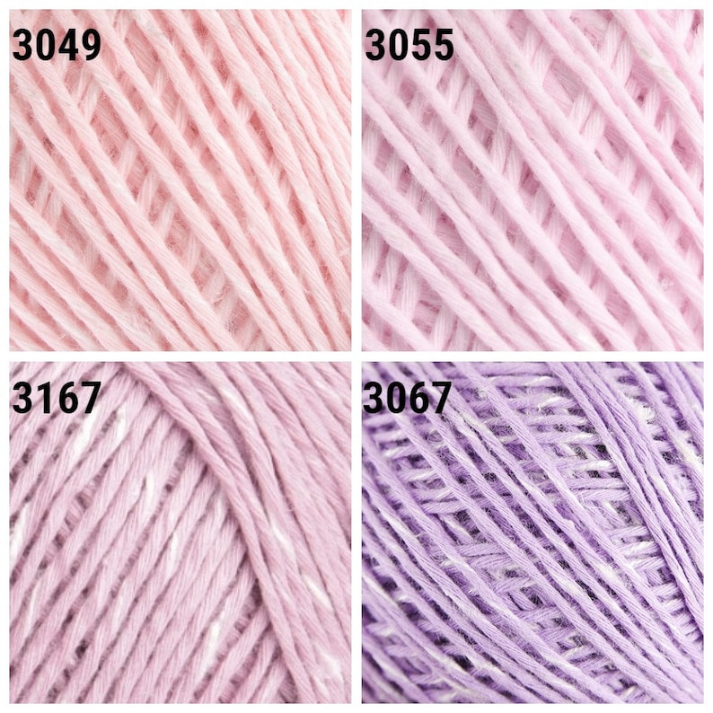 May include: Close-up of four skeins of yarn in different colors. The top left skein is a light pink, the top right skein is a slightly darker pink, the bottom left skein is a light lavender with white flecks, and the bottom right skein is a darker lavender with white flecks. Each skein has a number printed on it: 3049, 3055, 3167, and 3067.