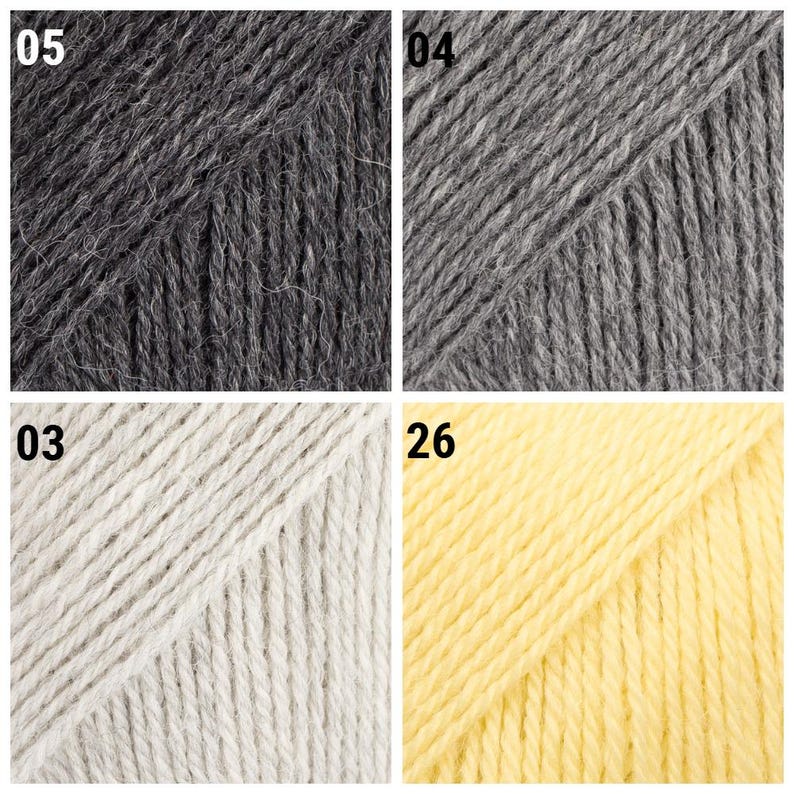 K&ouml;nnte beinhalten: Nahaufnahme von vier Garnkn&auml;ueln in verschiedenen Farben. Oben links dunkelgrau mit der Nummer "05". Oben rechts grau mit der Nummer "04". Unten links cremewei&szlig; mit der Nummer "03". Unten rechts gelb mit der Nummer "26".