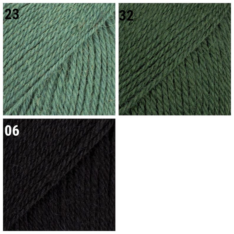 K&ouml;nnte beinhalten: Nahaufnahme von drei Garnkn&auml;ueln in verschiedenen Farben. Oben links ist ein ged&auml;mpftes Gr&uuml;n mit der Nummer 23. Oben rechts ist ein dunkleres Gr&uuml;n mit der Nummer 32. Unten ist ein schwarzes Kn&auml;uel mit der Nummer 06.