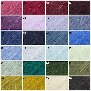 May include: A grid of twenty-four square swatches of fuzzy, textured yarn in various colors, each labeled with a two-digit number. The palette includes shades of pink, red, purple, blue, green, yellow, white, gray, and black, all with a soft, fibrous appearance.