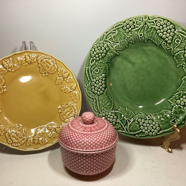 Choice of 3 Bordallo Pinheiro pieces, pink basket weave with lid, yellow turkey plate & green grape bowl, made in Portugal.  Some crazing.