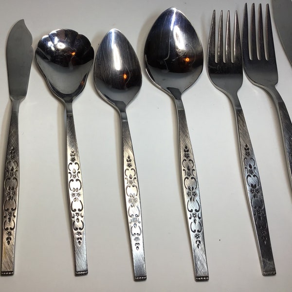 Spanada Wm A Rogers Preimier Stainless Oneida Ltd silverware flatware with embossed floral design on textured satin finish background