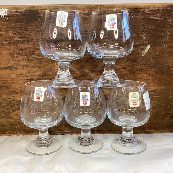 Choice of vintage clear or smoked gray Holmegaard Crystal cordial or aperitif glasses on raised pedestal.  Made in Copenhagen.