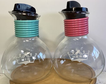 Vintage Cory His and Hers individual coffee carafes with lids. Pink and blue coil design.  Like new condition.  Great wedding gift.