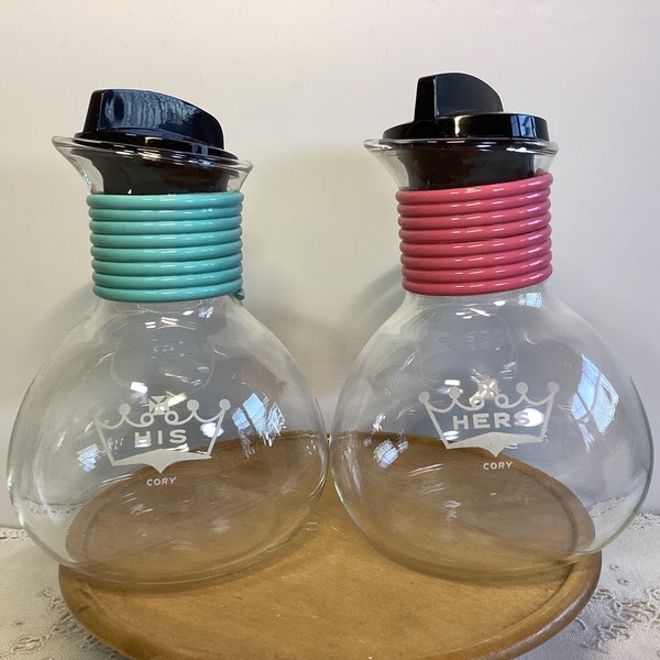 Vintage Cory His and Hers individual coffee carafes with lids. Pink and blue coil design.  Like new condition.  Great wedding gift.