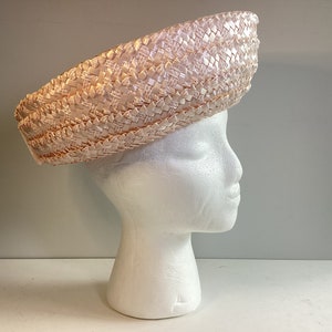 Vintage 1960s woven pink raffia spring summer brimmed straw hat with velvet bow on back. Excellent Condition.  Made in USA.
