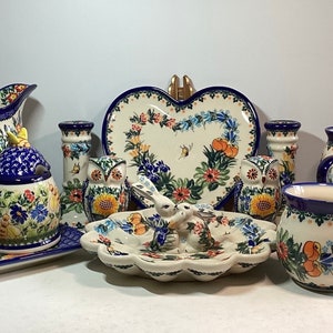 Choice of Boleslawiec Kalich Polish Pottery including mugs, plates, pitcher, honey jar, salt an pepper, candle sticks, and egg plate.