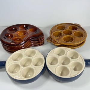 Choice of vintage escargot snail stuffed mushroom cooking dishes, Some marked Emile Henry. Excellent quality and condition.