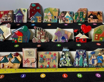 Choice of handmade House, Women, Little Ones and Book Pins by Lucinda. Smooth glossy finish with bright colors, & 3D texture.