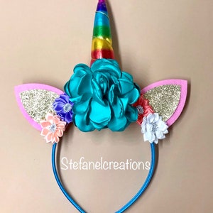 Unicorn headbands with flowers and unicorn ears. White headband for girls with rainbow unicorn horn and pink and gold ears
