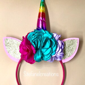 Unicorn headbands with flowers and unicorn ears. White headband for girls with rainbow unicorn horn and pink and gold ears