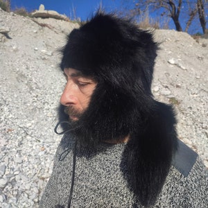 Raccoon trapper hat with tail