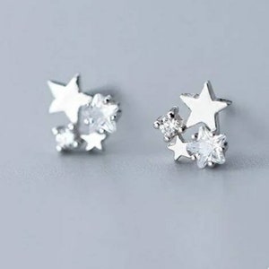 Tiny 925 sterling silver dainty sparkle star stud earrings. Super shiny and so cute! Sparkle star earrings.