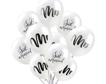 May include: White latex balloons with black lettering. Some balloons say "Just Married" and others say "Mr." or "Mrs."
