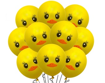 May include: A bunch of yellow rubber duck balloons with black eyes and orange beaks. The balloons are tied together with black strings.