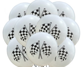 May include: A bunch of white balloons with black checkered flags printed on them. The balloons are tied together and ready for a party.