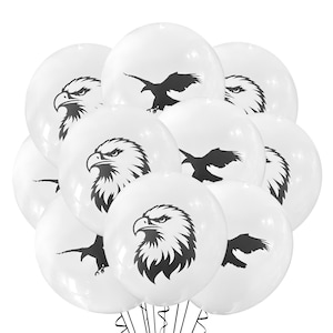 May include: A cluster of white balloons with black eagle illustrations. Some balloons feature a detailed eagle head, while others display an eagle in flight. The balloons are arranged closely together, creating a festive and decorative display.