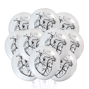 May include: A bunch of white latex balloons with a black anatomical heart design printed on each balloon.