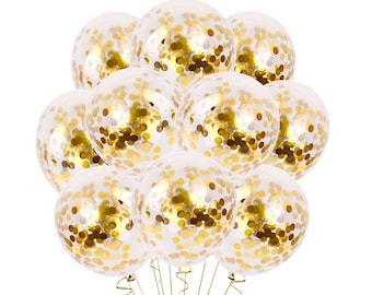 May include: A bunch of clear balloons filled with gold confetti. The balloons are tied together with gold ribbon.