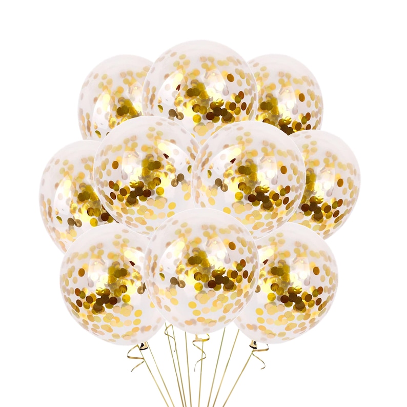 May include: A bunch of clear balloons filled with gold confetti. The balloons are tied together with gold ribbon.